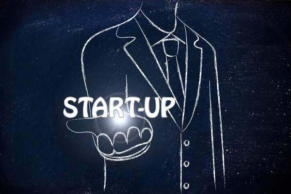 Uomo d'affari che tiene la parola Start-up — Foto Stock