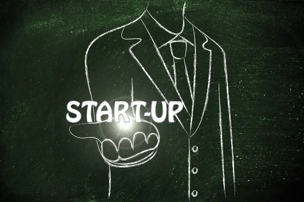 Uomo d'affari che tiene la parola Start-up — Foto Stock