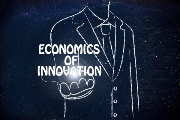 Business man holding the word Economics of Innovation