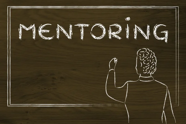 Teacher writing on blakboard about mentoring — Stock Photo, Image