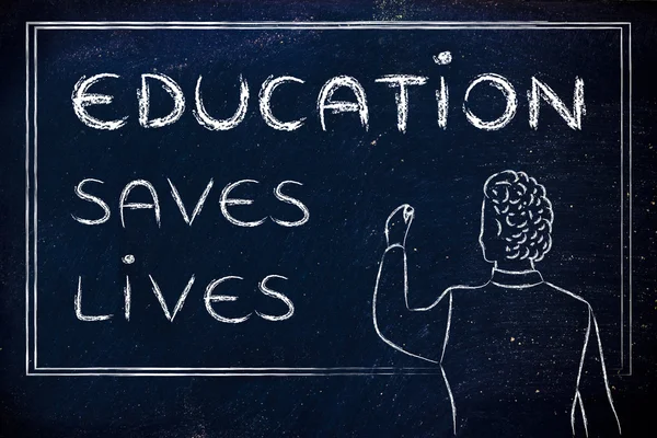 Teacher writing on blakboard: education saves lives — Zdjęcie stockowe