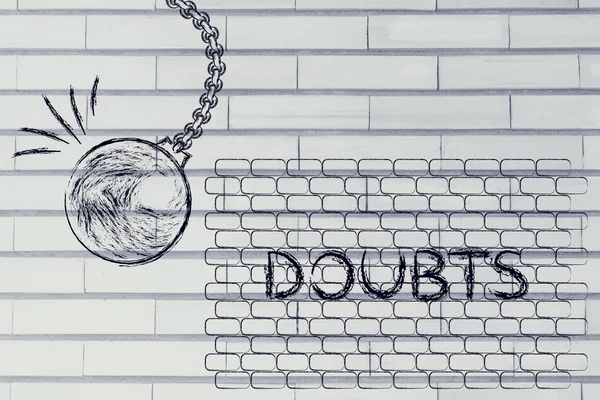 Wrecking ball about to destroy a wall with the text Doubts — 图库照片