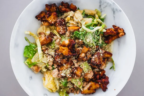 healthy green cabbage and iceberg lettuce salad with roasted teriyaki tofu and cashew dukkah, a high protein plant based meal for diabetes and general wellness