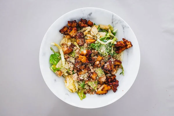 healthy green cabbage and iceberg lettuce salad with roasted teriyaki tofu and cashew dukkah, a high protein plant based meal for diabetes and general wellness
