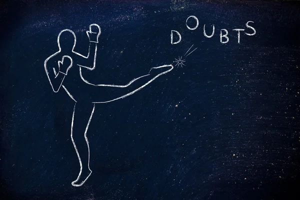 Person kicking and boxing the word doubts — Stock Photo, Image