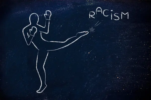 Person kicking and boxing the word racism — Stock Photo, Image