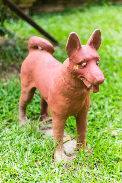 Thai dog statue on grass — Stock Photo, Image