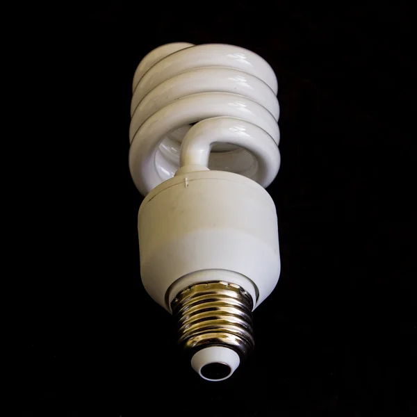 Fluorescent lamp energy saving on black — Stock Photo, Image