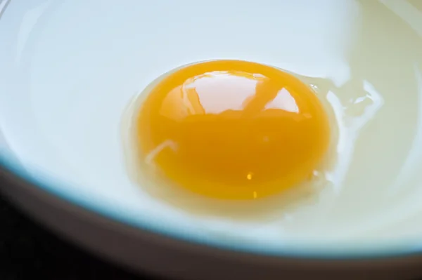 Raw yellow yolk in bowl — Stock Photo, Image