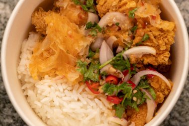 Delicious fried chicken with white rice or stream rice in the bucket.