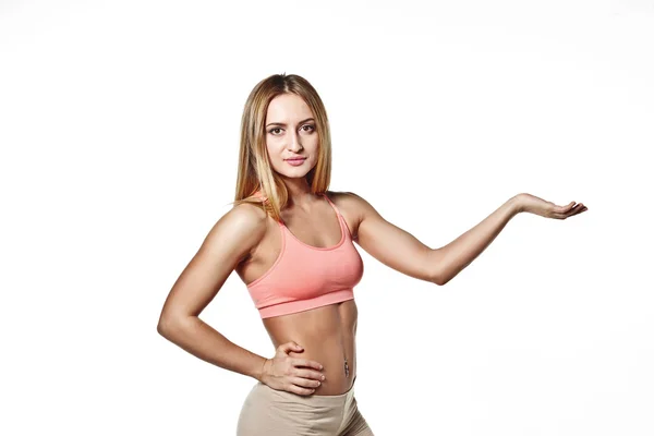 Beautiful young girl with a sports body with his hand raised up, on a white studio background space for your logo — Stock Fotó