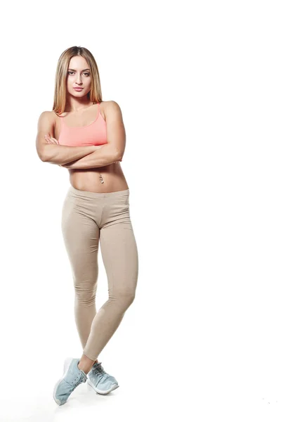 Beautiful young girl with a sports body, on a white studio background — Zdjęcie stockowe