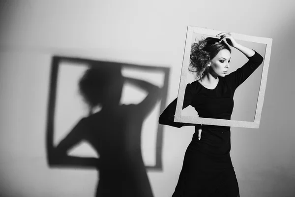 Charismatic woman with frame in hands with fashion poses. black white photo. negativity, loneliness, divorce, pain, depression — Stock Photo, Image