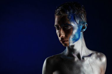 Crazy young androgyne man with face art. SPACEMAN. Freak person.