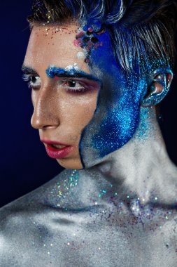 Crazy young androgyne man with face art. SPACEMAN. Freak person.