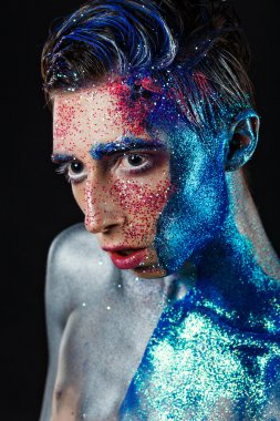 Crazy young androgyne man with face art. SPACEMAN. Freak person.