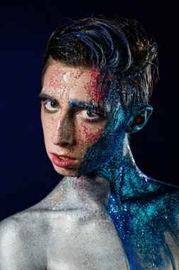 Crazy young androgyne man with face art. SPACEMAN. Freak person.