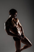 Muscular male model bodybuilder before training. Studio shot on 