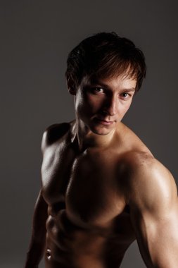 Strong Athletic Man showing muscular body and sixpack abs. Showi