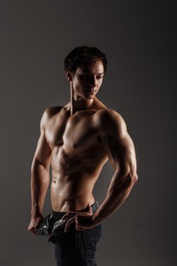 Muscular male model bodybuilder before training. Studio shot on  clipart
