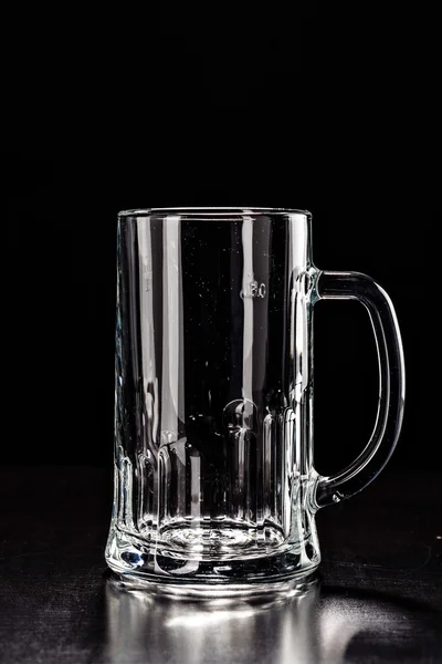 Glass for BEER on black. EMPTY GLASS. Glass of alcohol. Closeup