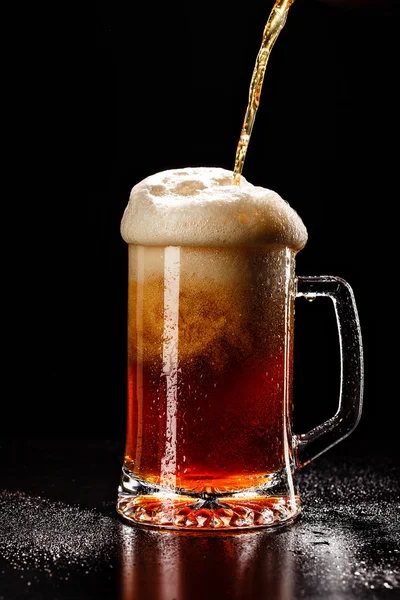 Process filling Beer Glass with DROPS on black. FRESH! MUCH FOAM