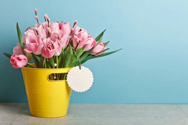 Bouquet of pink fresh tulips with pussy-willow in yellow bucket — Stock Photo, Image