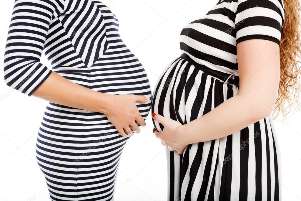 Two happy pregnant women is glasses touch their belly — Stock ...