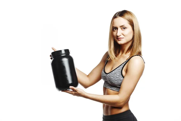 Szép fitness girl gazdaság jar, sport-tápanyag — Stock Fotó