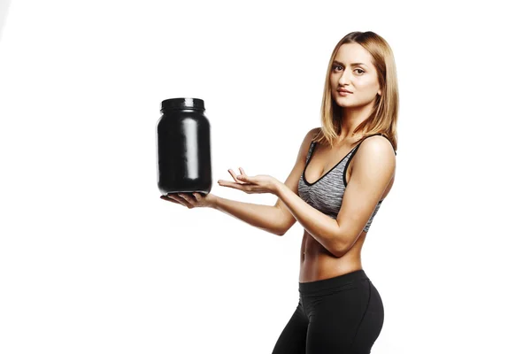 Vackra fitness tjej håller burk sport nutrition — Stockfoto