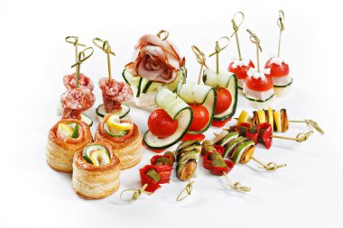 Nice set of canapes for one person with vegetables, cheese, fruits, berries, salami, seafood, meat and decoration on white background studio isolated with space for text template