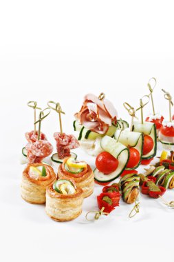 Nice set of canapes for one person with vegetables, cheese, fruits, berries, salami, seafood, meat and decoration on white background studio isolated with space for text template