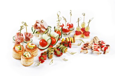 Nice set of canapes for one person with vegetables, cheese, fruits, berries, salami, seafood, meat and decoration on white background studio isolated with space for text template
