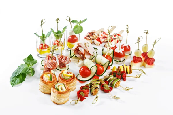 Nice set of canapes for one person with vegetables, cheese, fruits, berries, salami, seafood, meat and decoration on white background studio isolated with space for text template — ストック写真