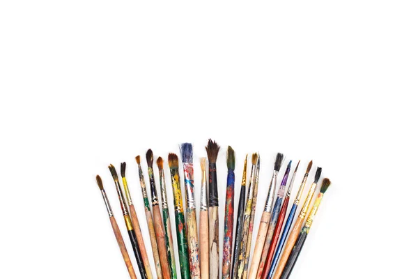 Big set of artist dirty paint brushes on white background with much space for text. Isolated image. — Stock Photo, Image