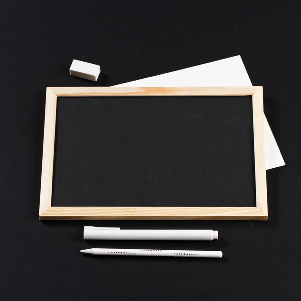 Wooden frame with black field with marker and white pencil and e — ストック写真