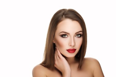 young beautiful brunette woman with makeup and red lips with hand at face. isolated photo