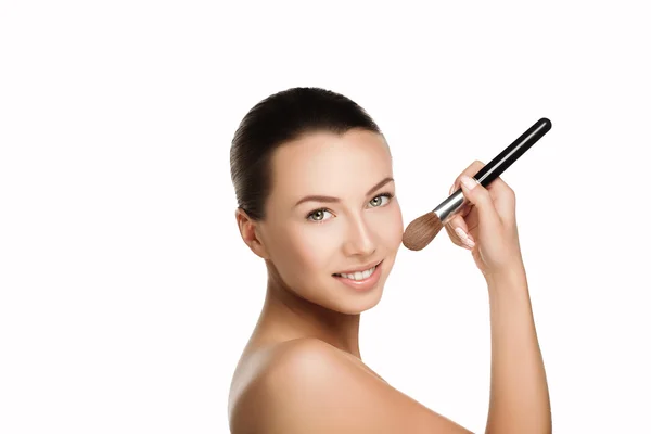 Young beautiful brunette woman with nude makeup smile and hold brush at face. naturalness isolated photo. — Stock Photo, Image