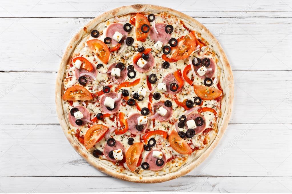 Delicious fresh pizza served on wooden table. Top view. 