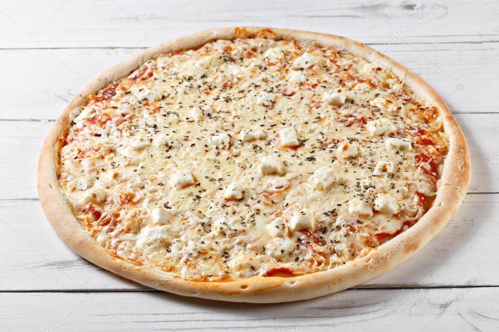 Delicious four cheeses pizza served on wooden table. quattro for