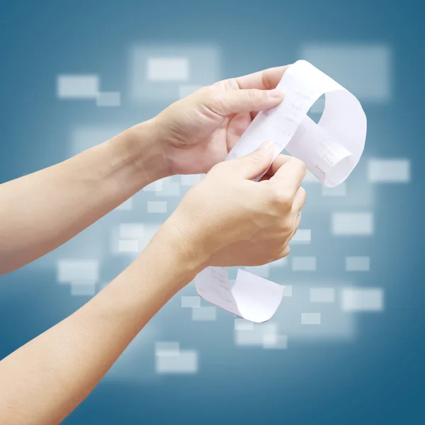 Hand of woman checking a long  receipt — Stock Photo, Image