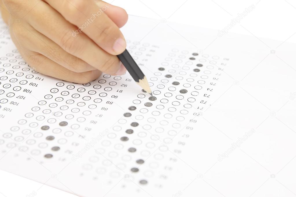 Standardized test form with answers bubbled in and a pencil, foc