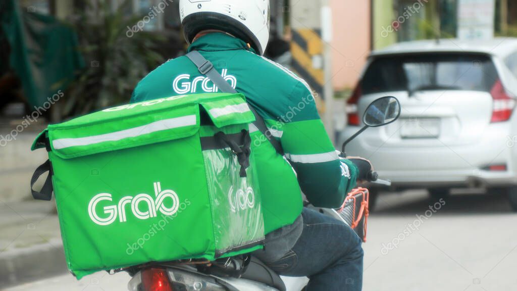 THAILAND OCT-16 : Grab food man is sending the food by motorcycle at the street to his customer, be serve job that very popular in Thailand, OCTOBER-16 2020 at Bangkok Thailand.