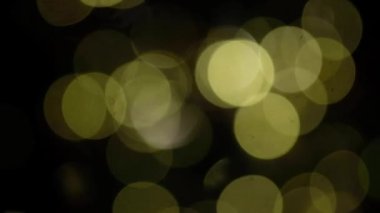 Siyah arkaplanda soyut dairesel sarı bokeh