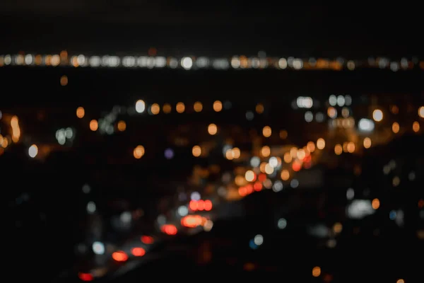 Blur background of street lights of urban city street at night. High angle view