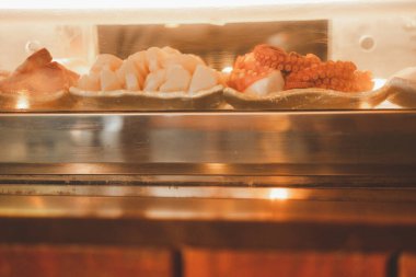 Sashimi taze yemeklerinin çoğu Suşi restoranının barındaki Showcase 'de kalamar ve balık olarak yenir. Kapat.