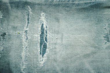 Blue torn jeans texture of denim jeans background