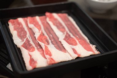 Plate of thin sliced beef meat for hot pot also known as Shabu Shabu or Sukiyaki, Japanese food style.