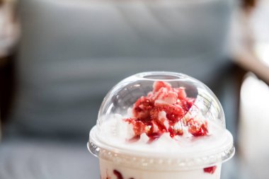Closeup top of strawberry mix yogurt smoothies in plastic cup. Refreshment healthy drink