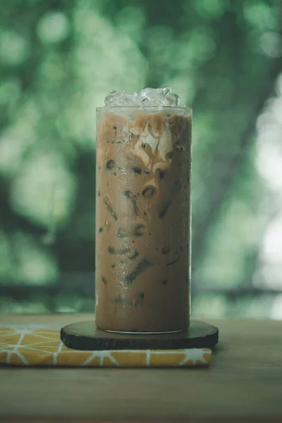 Ice coffee Mocha in a tall glass against nature background